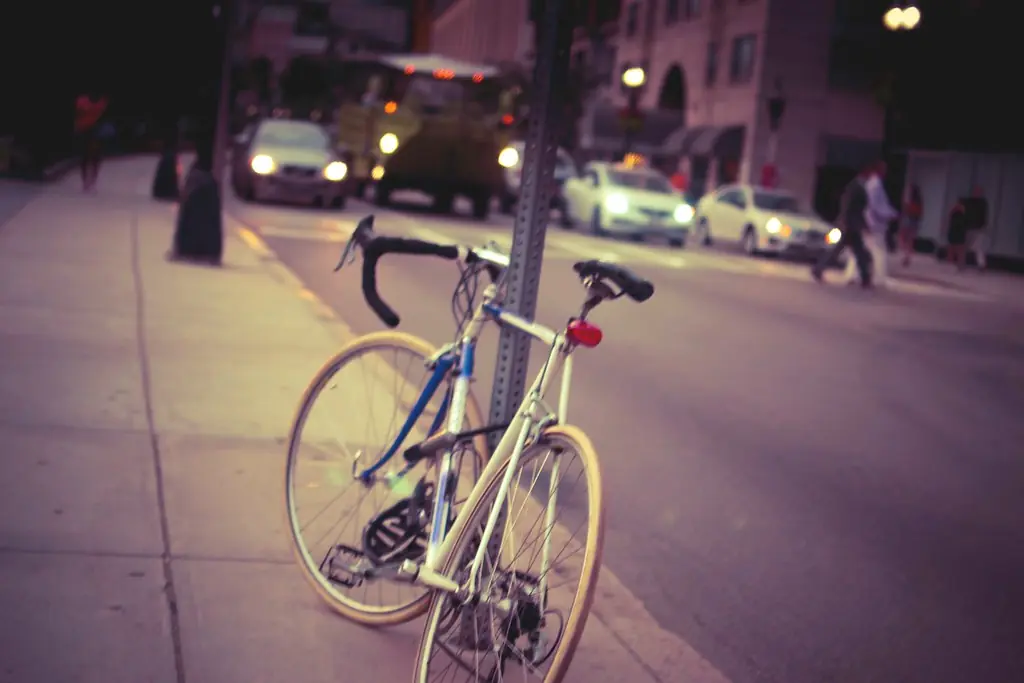 A bicycle parked on a city street at night