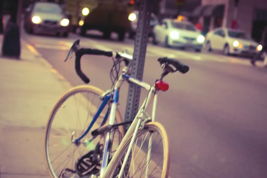 A bicycle parked on a city street at night