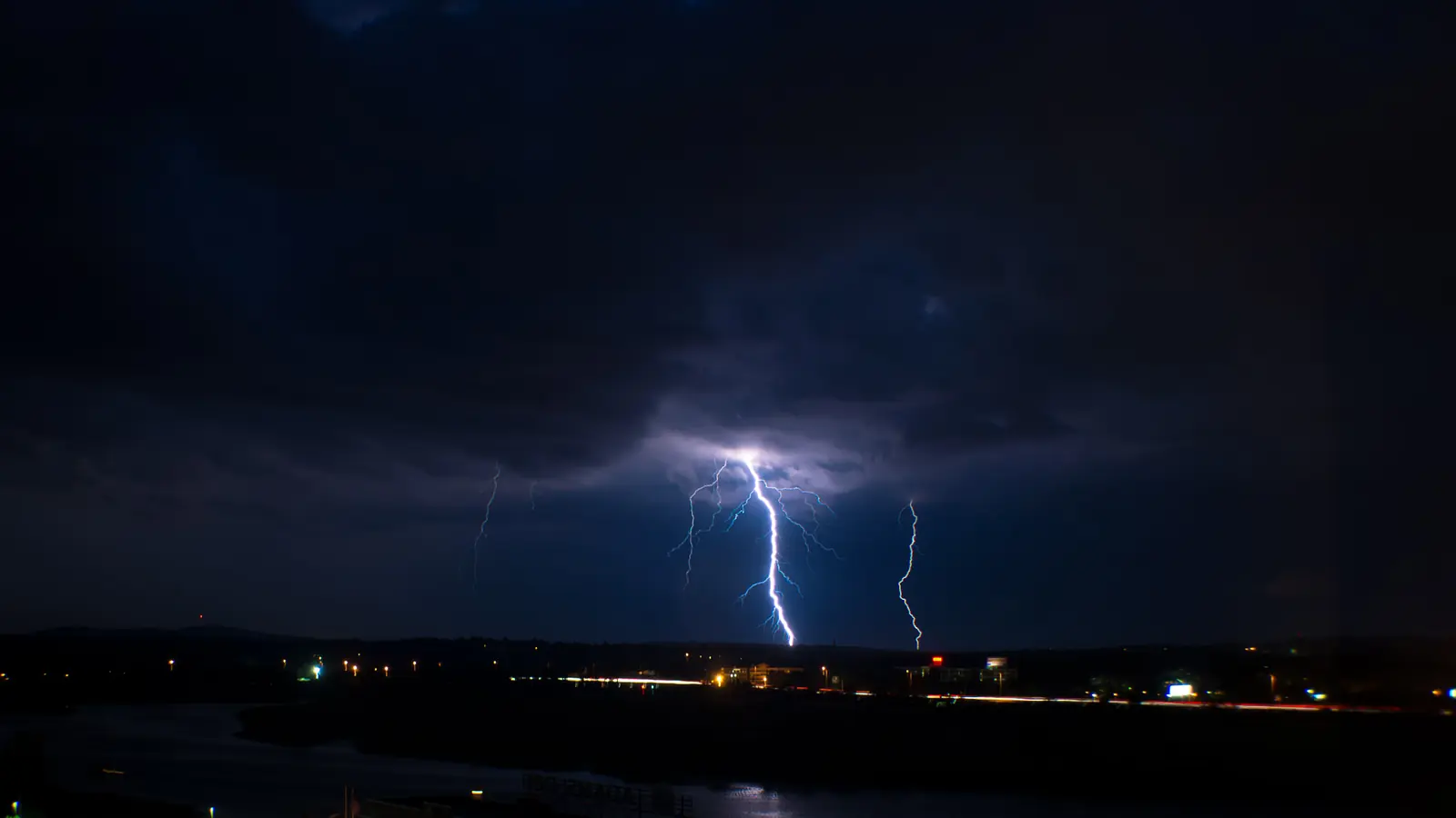 Lightning splitting a dark sky over Boston during a thunderstorm